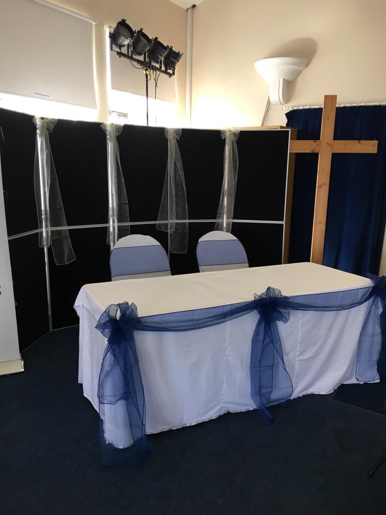 Photo of the church register signing table, white table cloth and blue ribbon